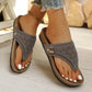 Zyra women's grey suede-like laser-cut thong platform sandals worn on feet with white toenails, showcasing the cork-patterned footbed and gold buckle detail.