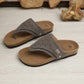 Grey suede-like PU thong sandals with intricate laser-cut geometric patterns and gold-tone buckle details, featuring a cork-patterned footbed and platform rubber sole.