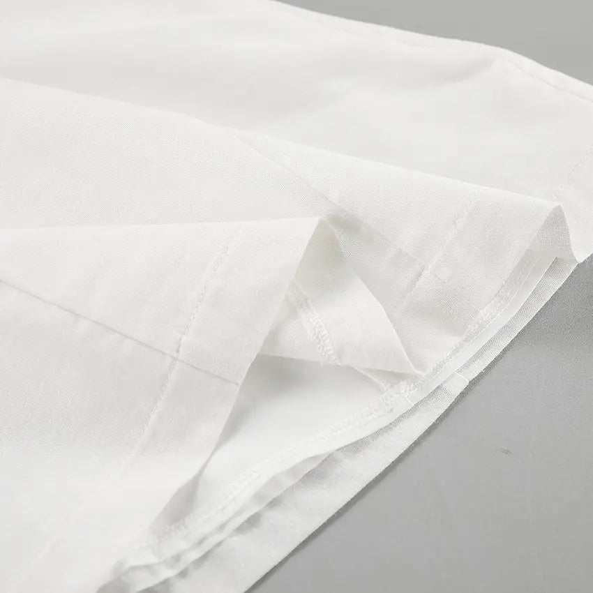 Close-up view of the luxurious off-white 100% linen fabric from the Zyra Linen Set, highlighting its natural texture and artisanal stitching details.
